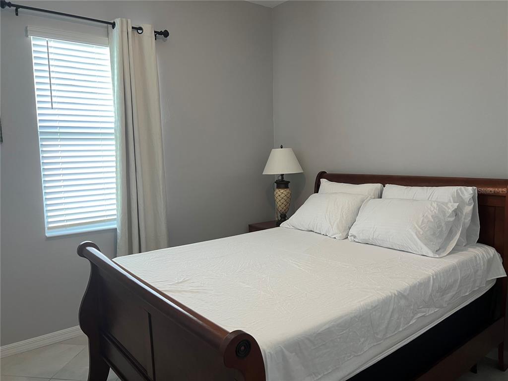 17535 Jadestone Court Venice, FL 34293 - Photo 33 of 92 a bedroom with a bed and a window