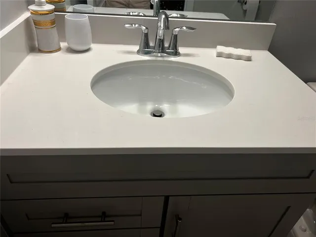 a view of a field of grass and trees