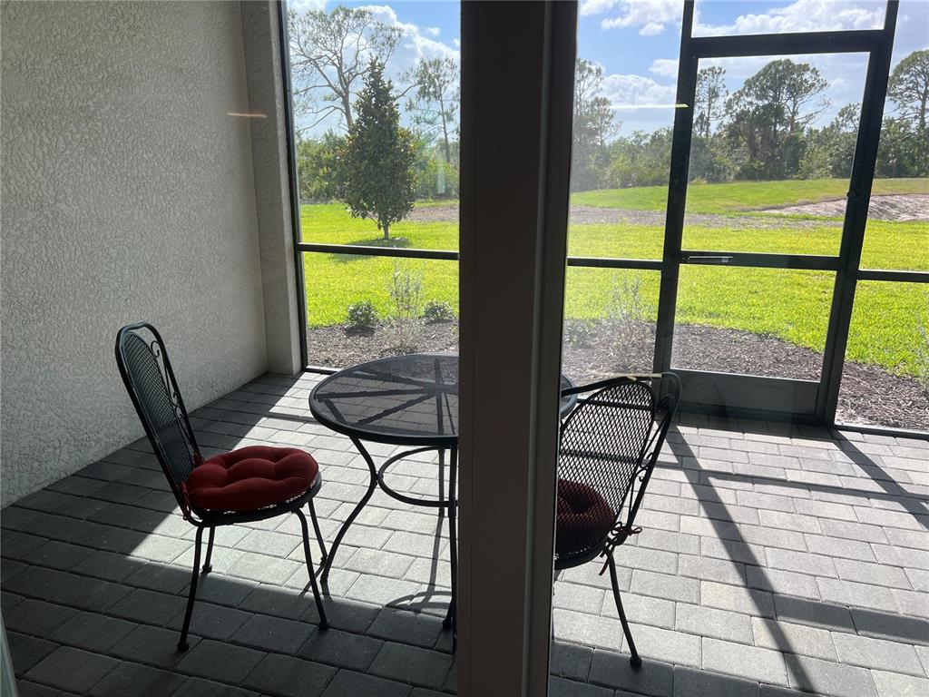 17535 Jadestone Court Venice, FL 34293 - Photo 49 of 92 a view of a balcony with chairs and wooden floor