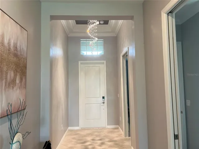 a kitchen with kitchen island a stove a sink and a refrigerator with white cabinets