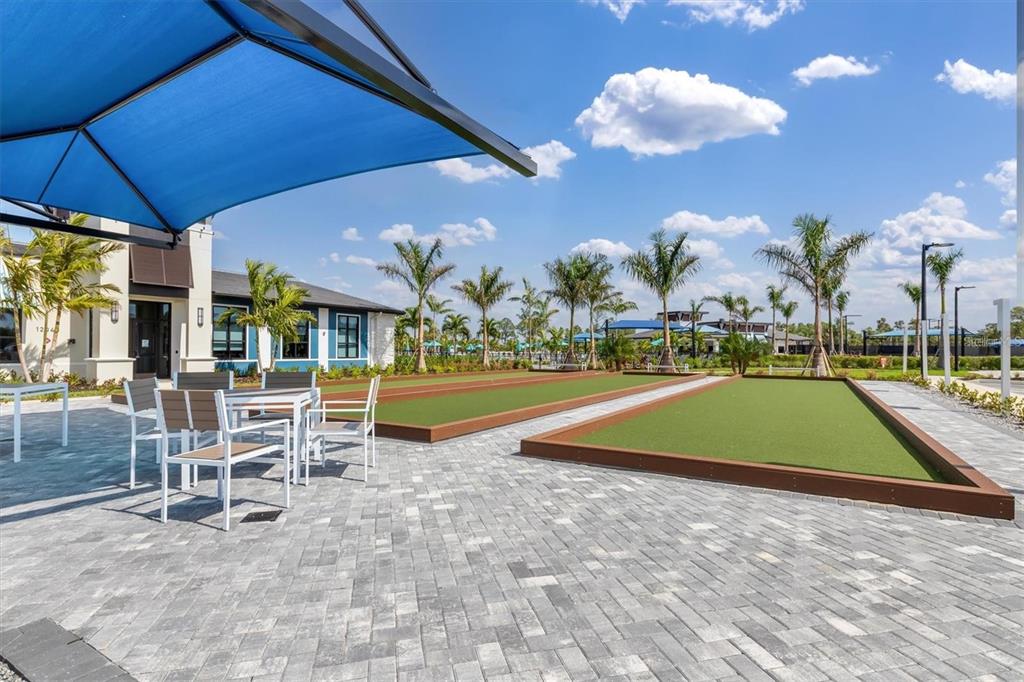 17535 Jadestone Court Venice, FL 34293 - Photo 66 of 92 a view of a swimming pool with a table and chairs under an umbrella