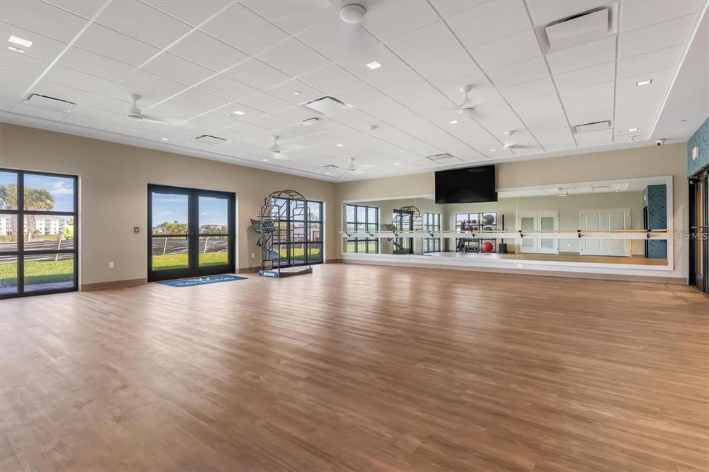 17535 Jadestone Court Venice, FL 34293 - Photo 74 of 92 a view of an empty room with window and wooden floor