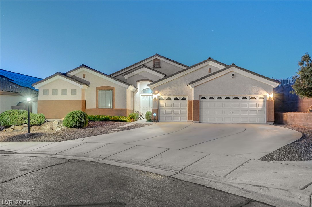 1604 Cattle Ranch Place Henderson, NV 89002 - Photo 82 of 99 A welcoming driveway leads to this charming home with an attached garage and well-maintained landscaping.