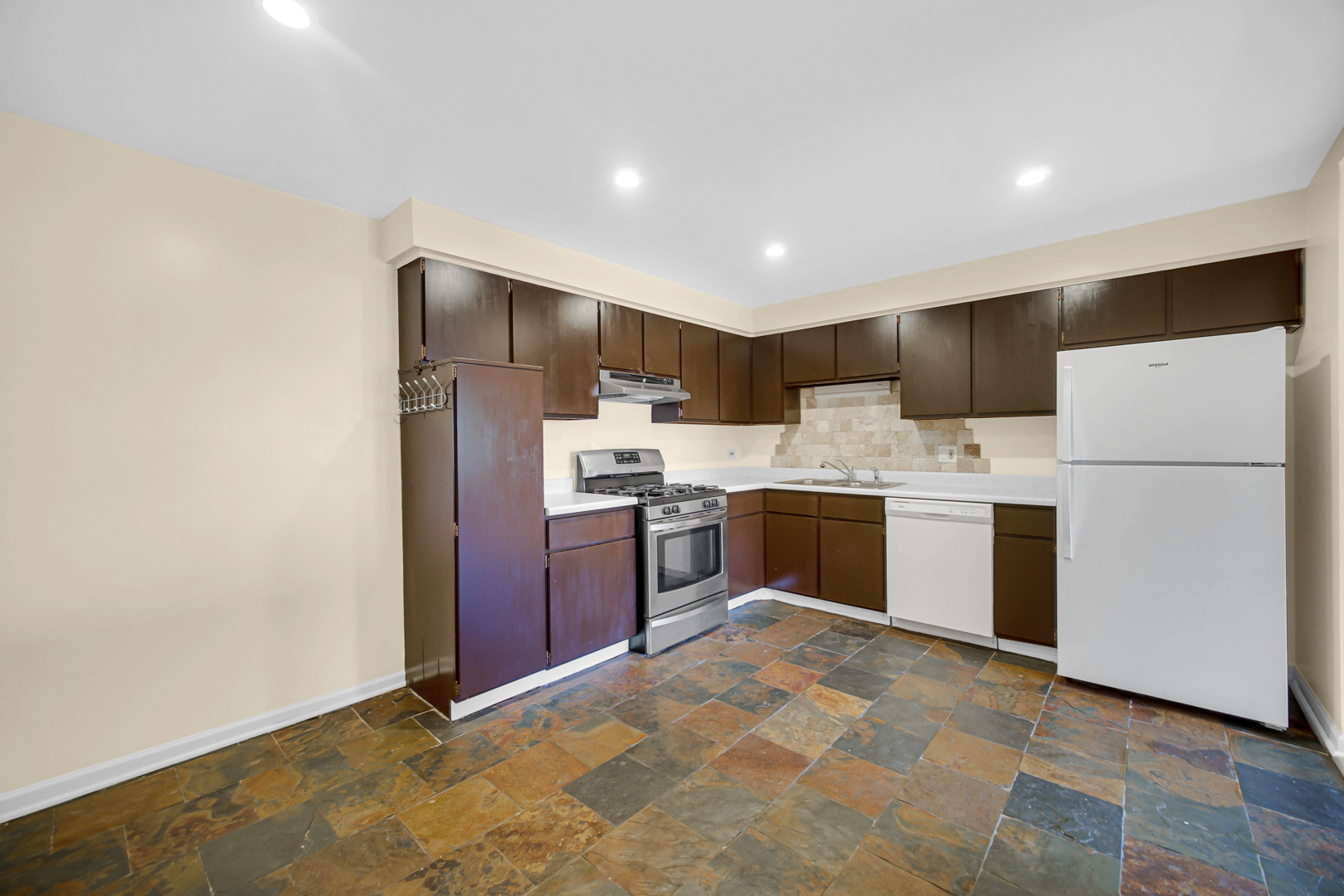 1211 Brown Street, Unit 3B Des Plaines, IL 60016 - Photo 5 of 14 a kitchen with stainless steel appliances a refrigerator sink and microwave
