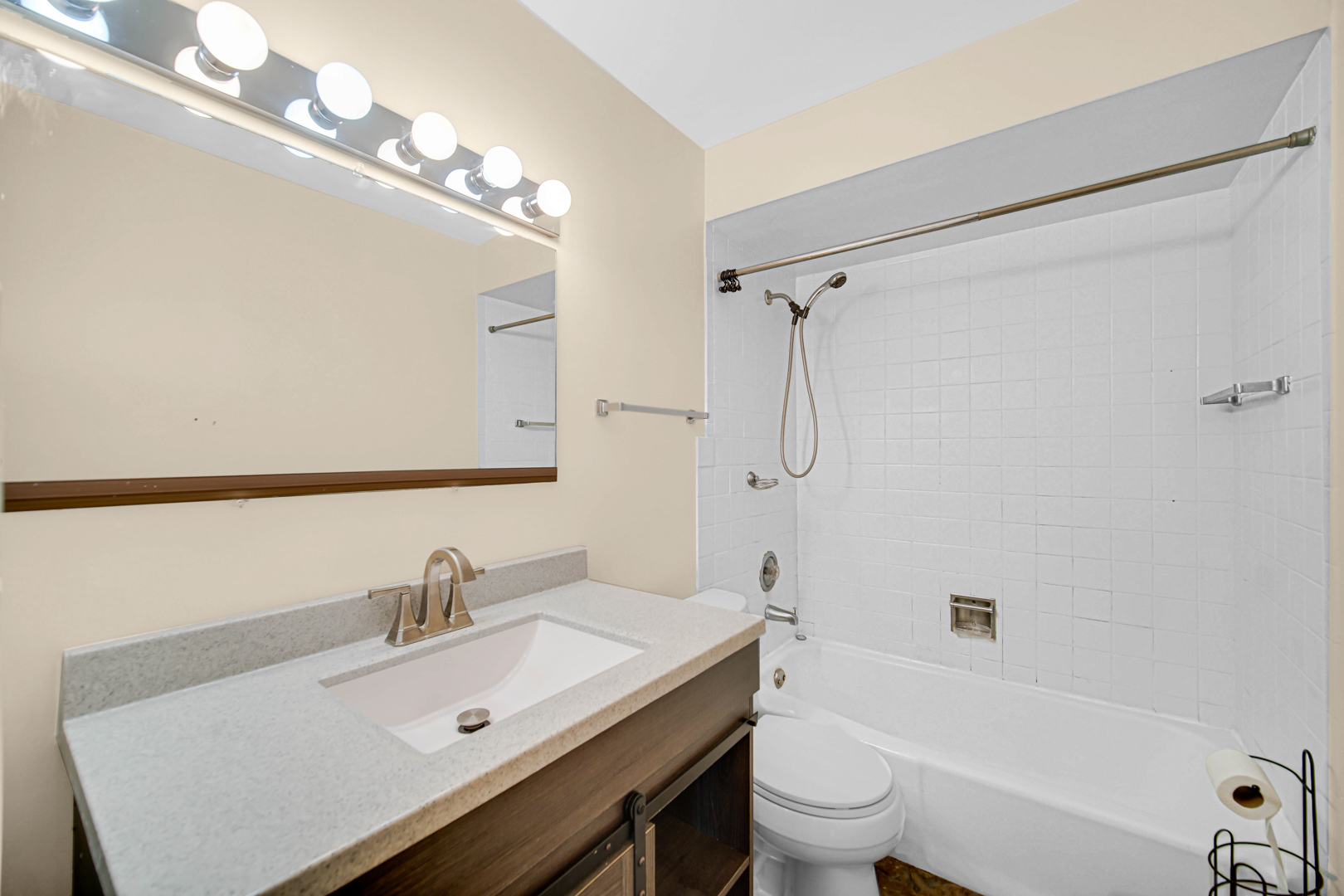 1211 Brown Street, Unit 3B Des Plaines, IL 60016 - Photo 9 of 14 a bathroom with a sink a toilet a mirror a vanity and shower