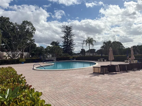 a view of a swimming pool with a yard