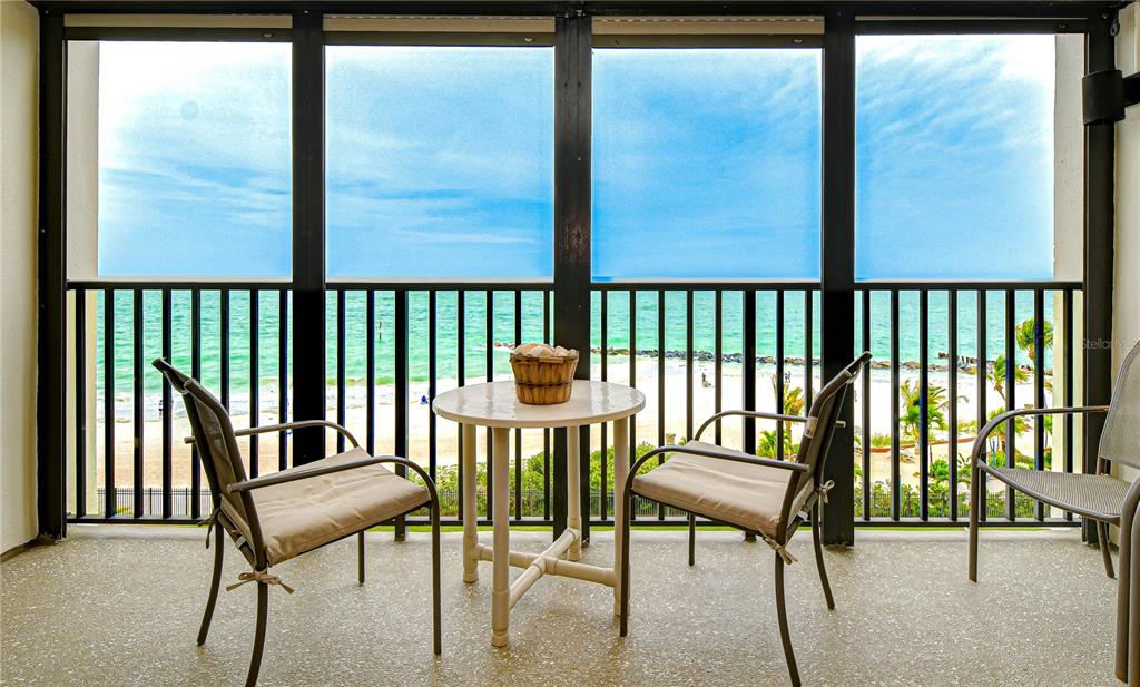 7100 Sunset Way, Unit 505 St. Pete Beach, FL 33706 - Photo 1 of 28 a view of a balcony with chairs