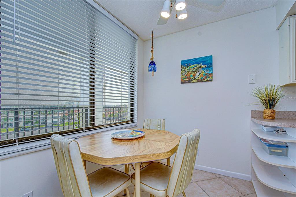 7100 Sunset Way, Unit 505 St. Pete Beach, FL 33706 - Photo 13 of 28 a view of a dining room with furniture and window