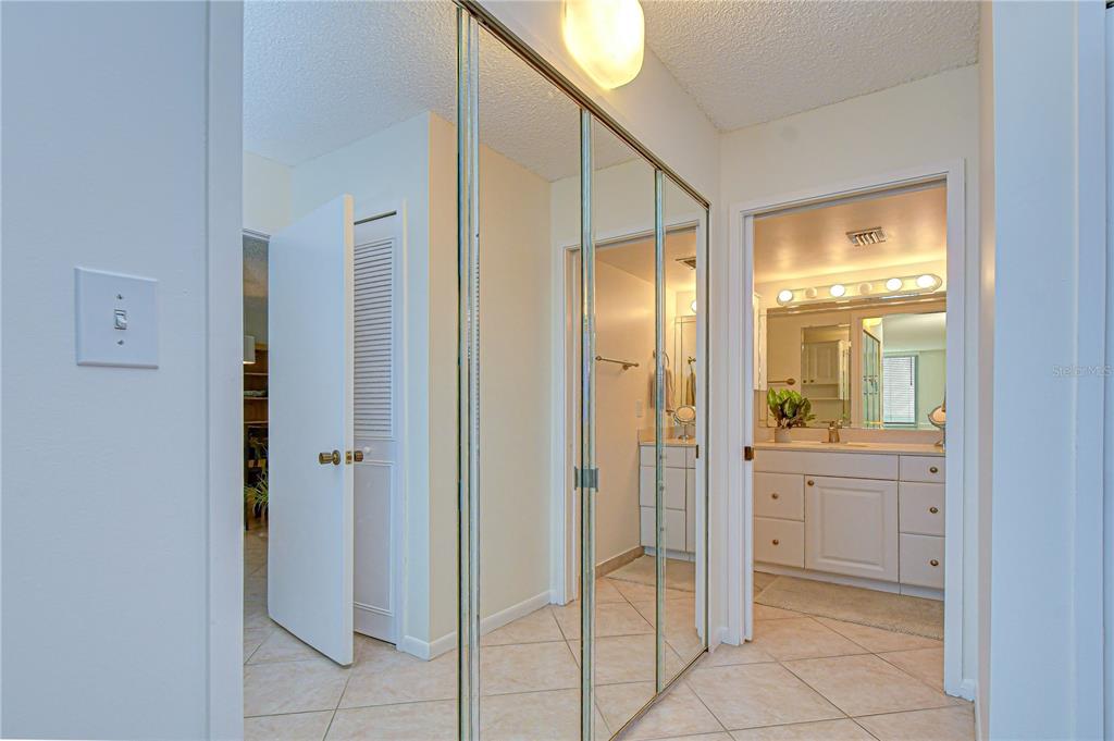 7100 Sunset Way, Unit 505 St. Pete Beach, FL 33706 - Photo 19 of 28 a bathroom with a glass shower door