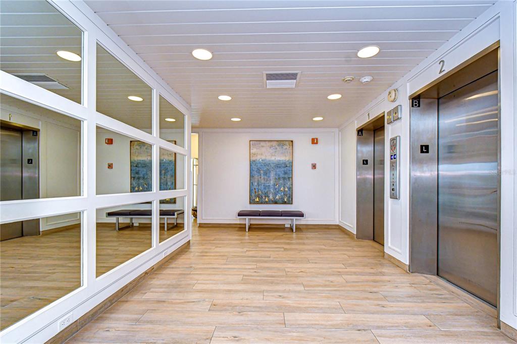 7100 Sunset Way, Unit 505 St. Pete Beach, FL 33706 - Photo 21 of 28 a view of a building with a potted plant and floor to ceiling window