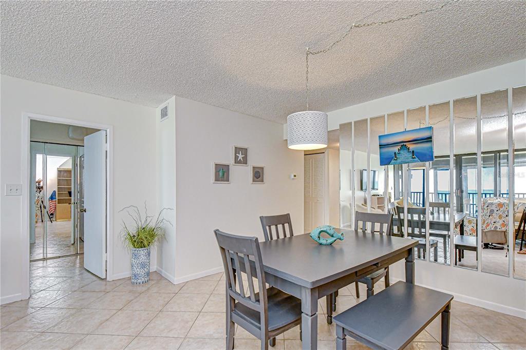 7100 Sunset Way, Unit 505 St. Pete Beach, FL 33706 - Photo 4 of 28 a view of a dining room with furniture