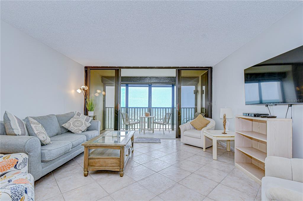 7100 Sunset Way, Unit 505 St. Pete Beach, FL 33706 - Photo 5 of 28 a living room with furniture and a large window
