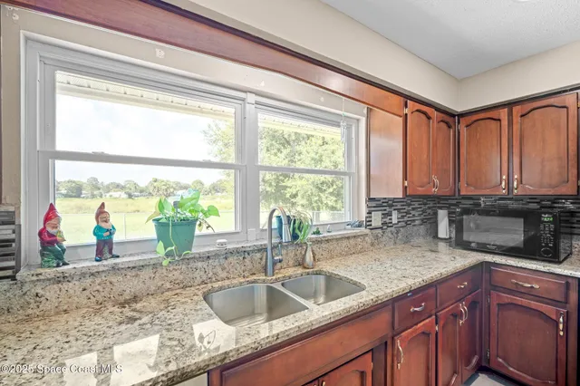 a kitchen with stainless steel appliances granite countertop a stove and a refrigerator