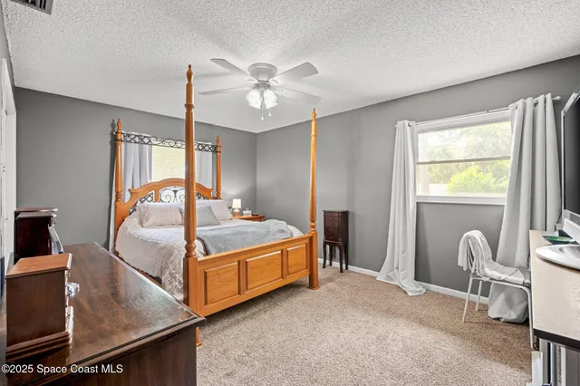 a bed room with a bed and a chair