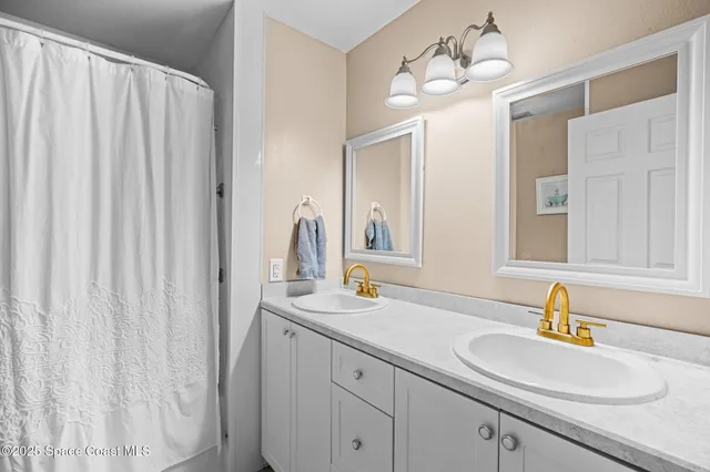 a bathroom with a sink mirror toilet and window