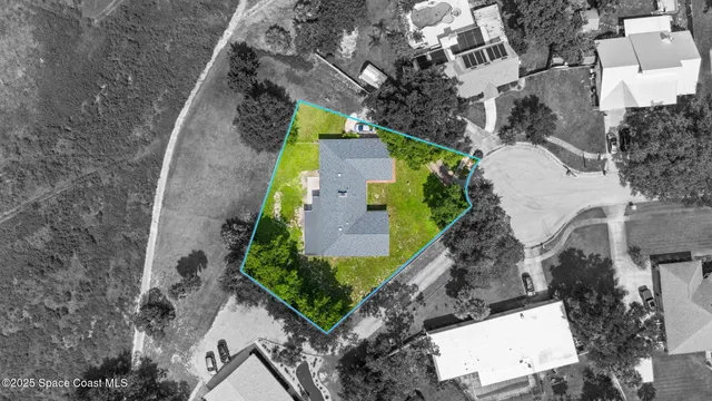 an aerial view of a house with outdoor space