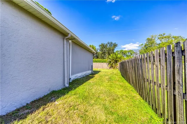 a view of a backyard with wooden fence
