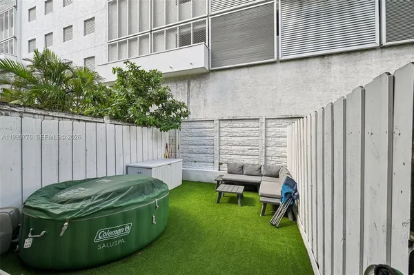 a view of a chair and table in backyard of house