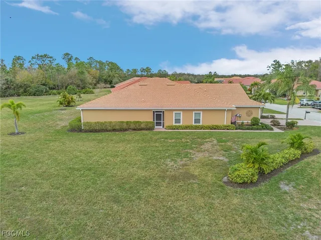 a aerial view of a house with yard and green space