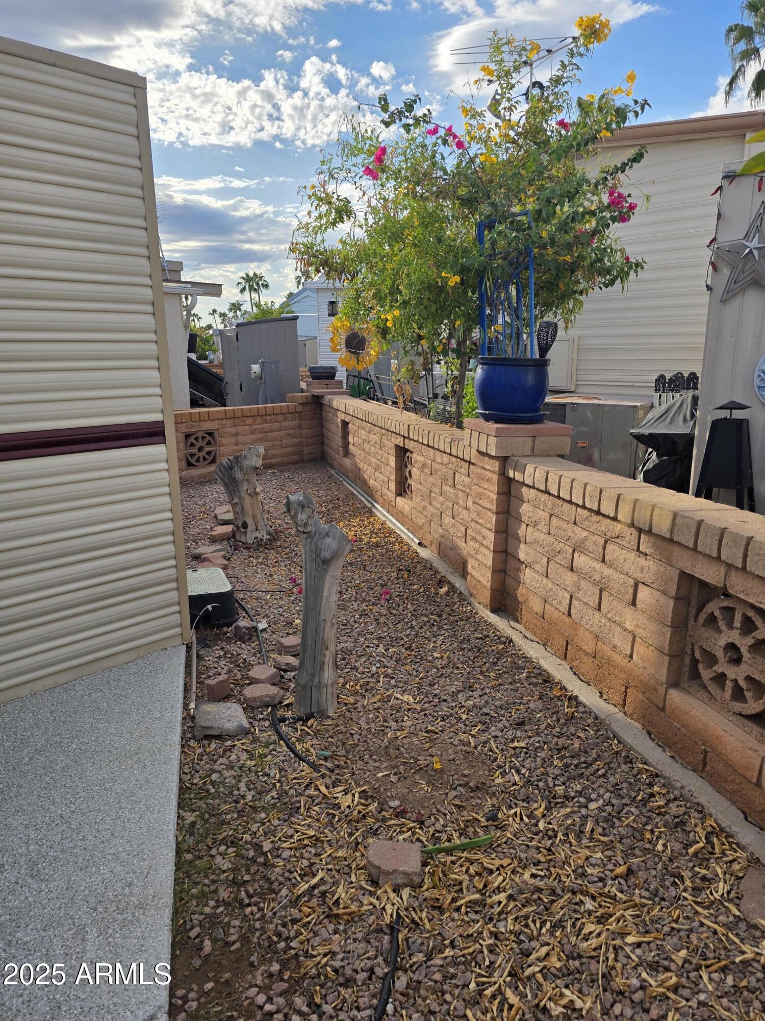 1315 West Chesapeake Avenue, Unit 315 Apache Junction, AZ 85119 - Photo 5 of 10 a view of a house with a flower garden