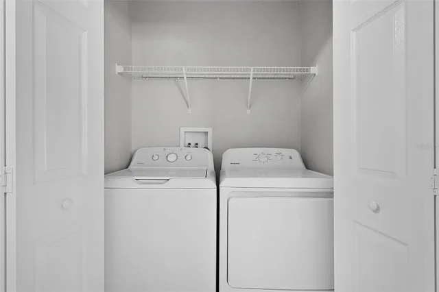 an empty room with a window and ceiling fan