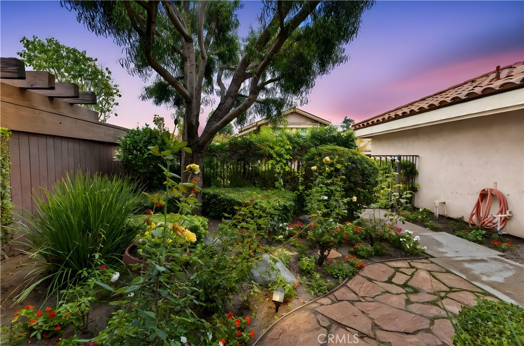 513 Pebble Beach Place Fullerton, CA 92835 - Photo 30 of 42 a yard with yellow house and potted plants