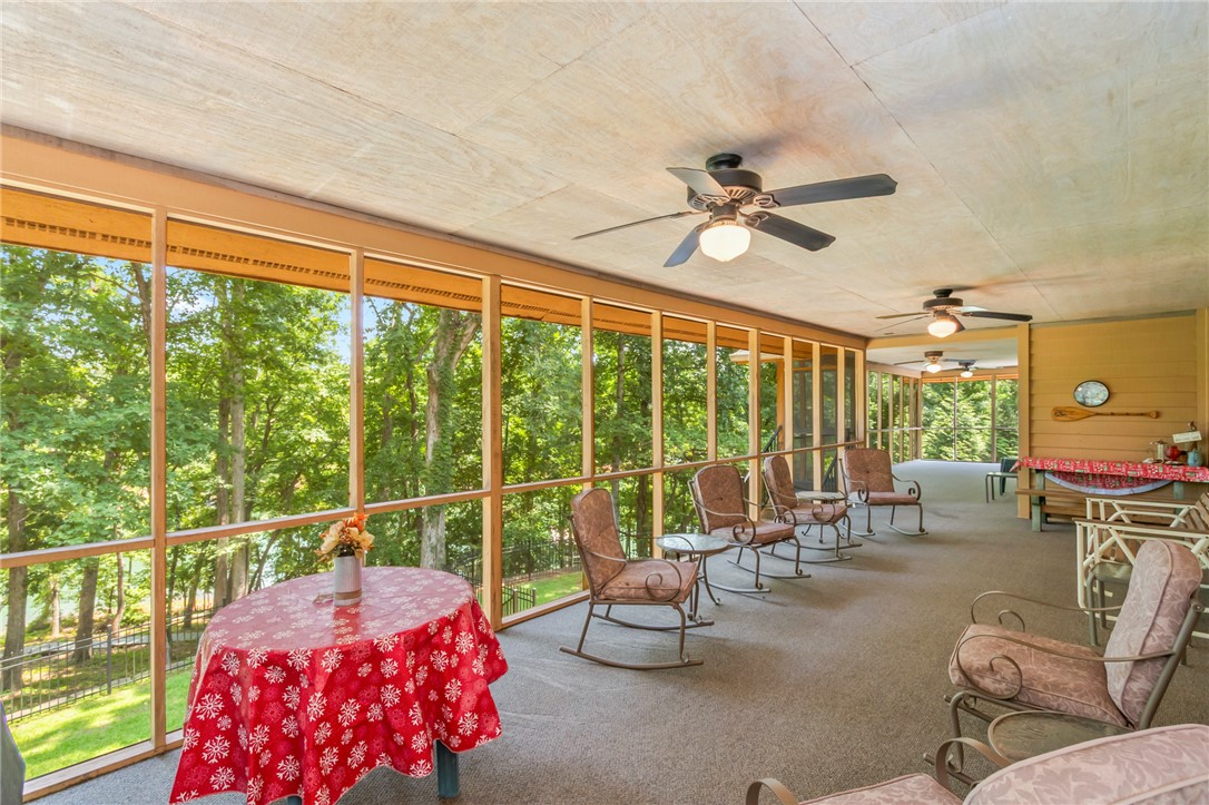 202 Plantation Point Anderson, SC 29625 - Photo 29 of 48 An inviting screened porch offers serene treetop vistas, perfect for tranquil relaxation.
