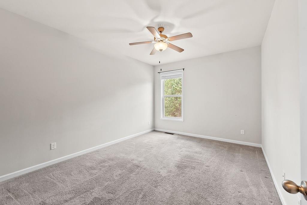 2415 Matlin Way Buford, GA 30519 - Photo 23 of 66 an empty room with a window and a fan