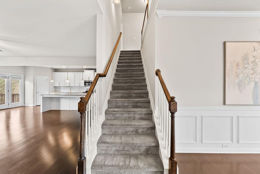 2415 Matlin Way Buford, GA 30519 - Photo 25 of 66 a view of entryway and hall with wooden floor