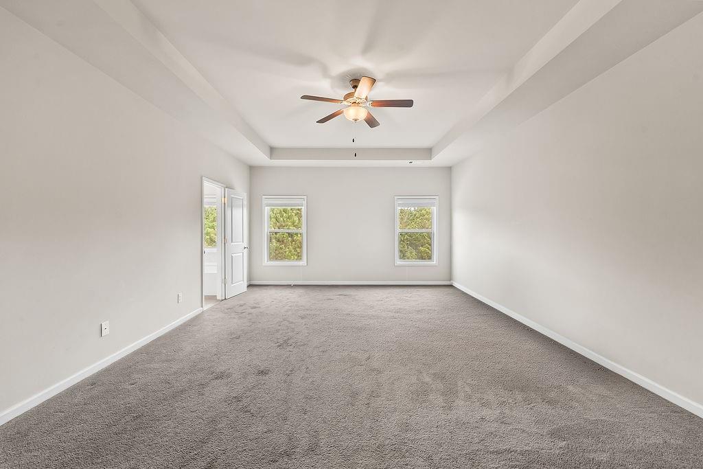 2415 Matlin Way Buford, GA 30519 - Photo 26 of 66 an empty room with windows and fan