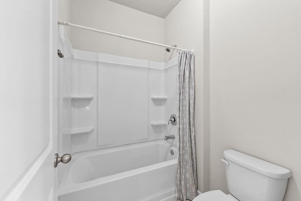 2415 Matlin Way Buford, GA 30519 - Photo 42 of 66 a bathroom with a shower and a toilet