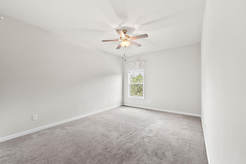 2415 Matlin Way Buford, GA 30519 - Photo 43 of 66 an empty room with a window and a fan