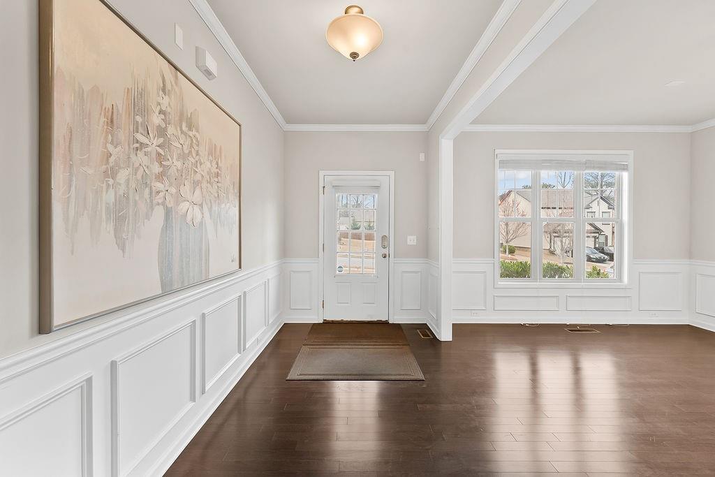 2415 Matlin Way Buford, GA 30519 - Photo 5 of 66 a view of an empty room with wooden floor and a window
