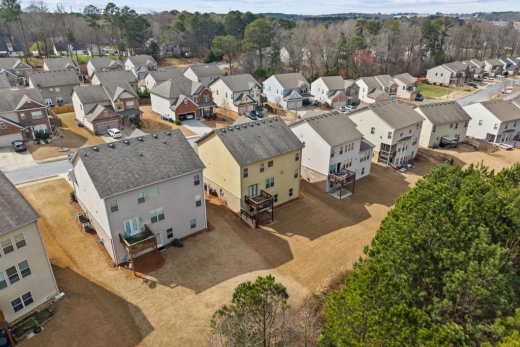 2415 Matlin Way Buford, GA 30519 - Photo 59 of 66 an aerial view of a house with a yard and parking
