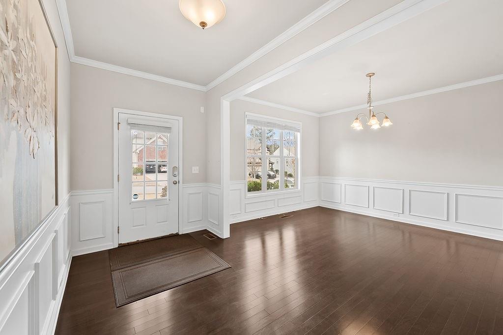 2415 Matlin Way Buford, GA 30519 - Photo 7 of 66 wooden floor in an empty room with a window