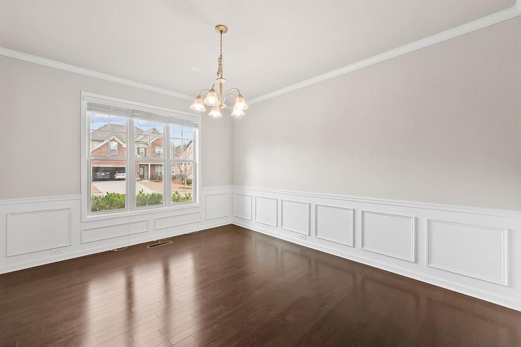 2415 Matlin Way Buford, GA 30519 - Photo 9 of 66 a view of an empty room with wooden floor and a window