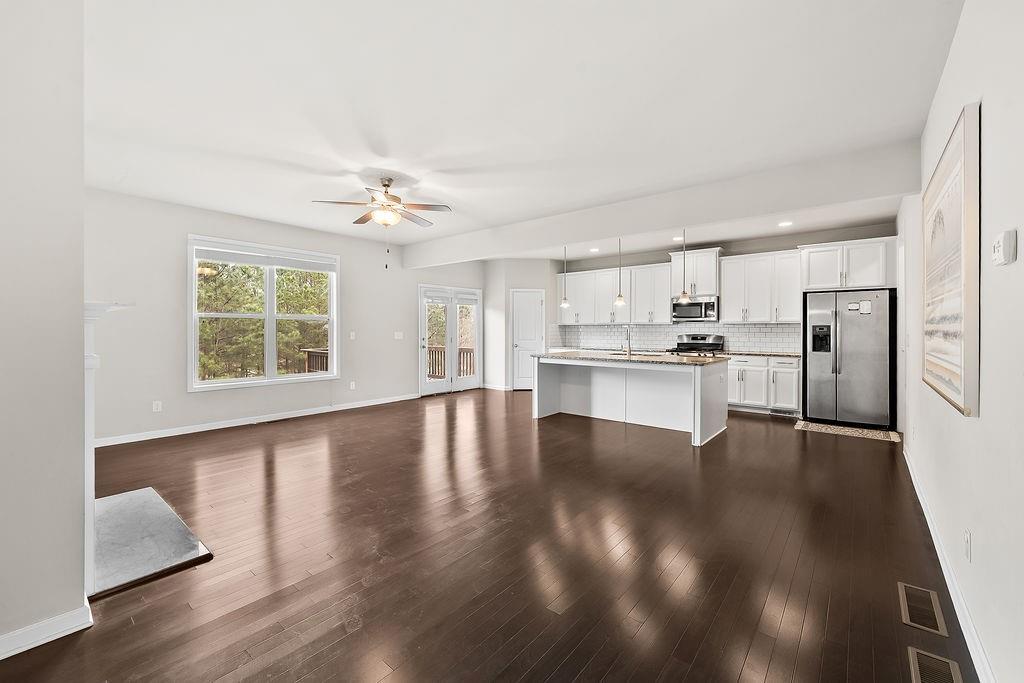 2415 Matlin Way Buford, GA 30519 - Photo 10 of 66 a view of kitchen with wooden floor electronic appliances and window