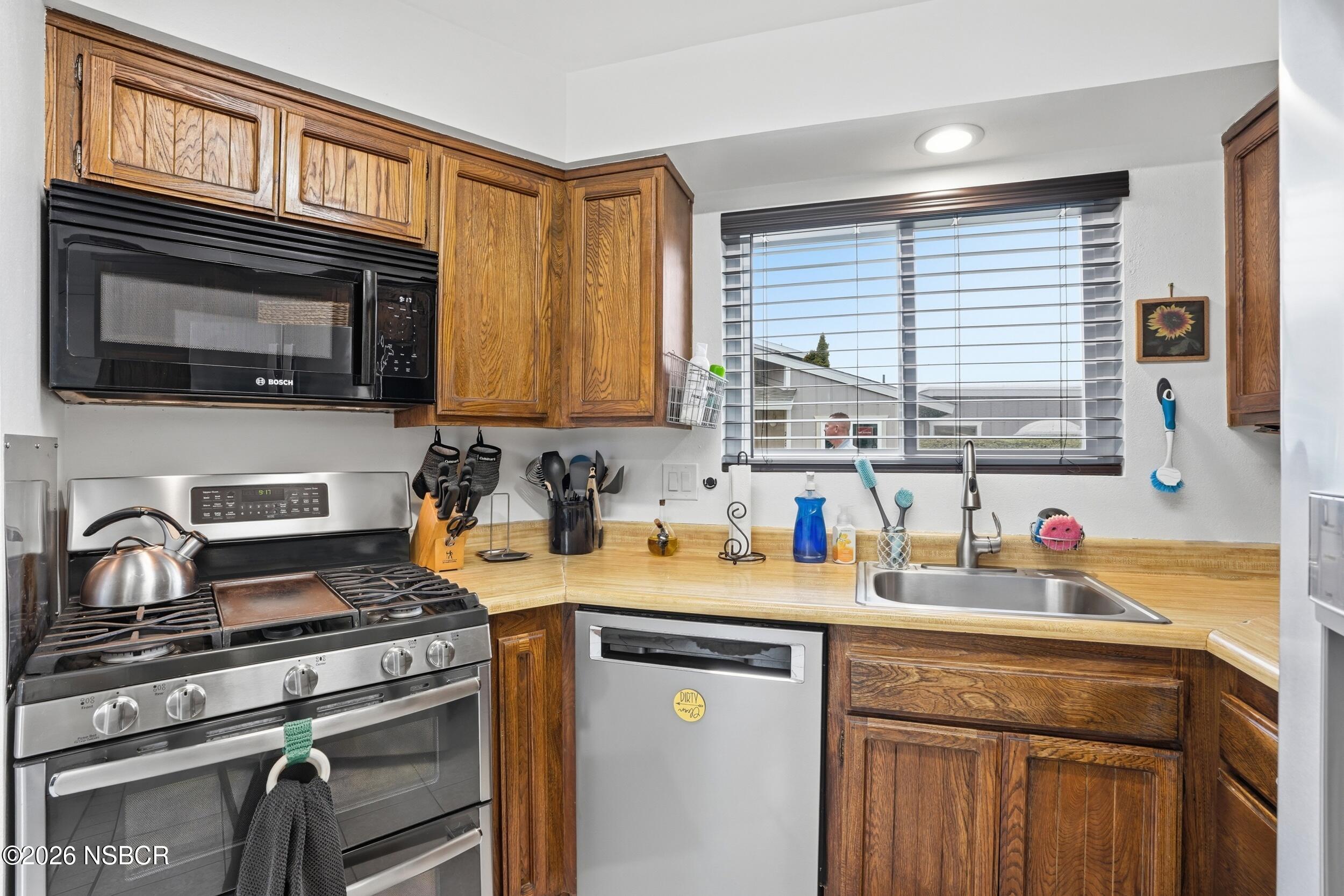 218 North R Street Lompoc, CA 93436 - Photo 14 of 24 a kitchen with a stove and a sink