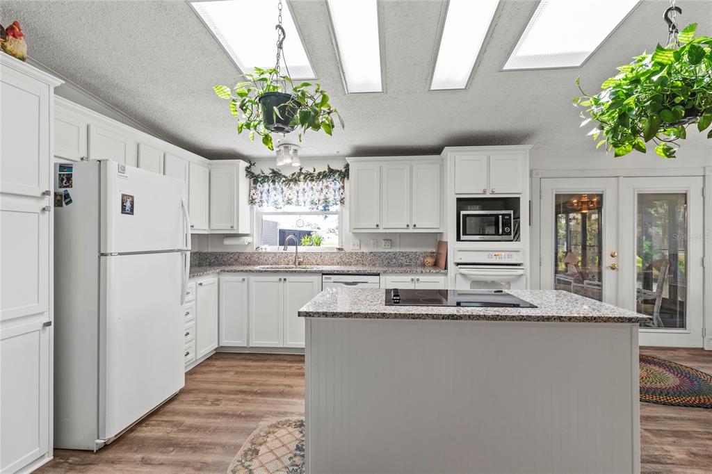 83 Eagle Circle Ellenton, FL 34222 - Photo 17 of 60 a kitchen with stainless steel appliances granite countertop a refrigerator sink stove and white cabinets