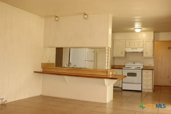 a kitchen with stainless steel appliances granite countertop a sink and cabinets