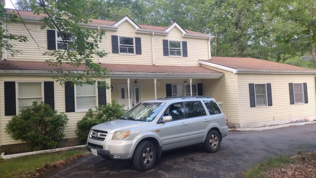 a front view of a house with a garden