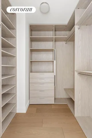 a view of walk in closet with empty racks
