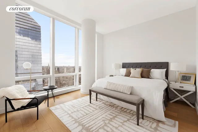 a bedroom with a bed a table and window