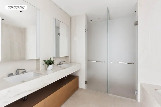 a bathroom with a double vanity sink a mirror and a shower
