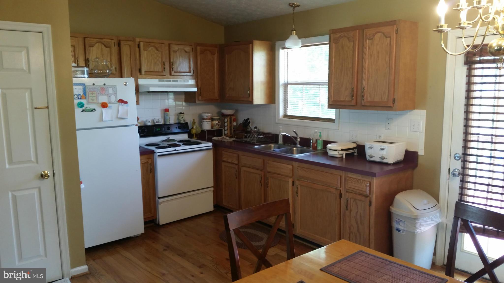 203 Preston Ranson, WV 25438 - Photo 3 of 12 a kitchen with a sink a window and cabinets