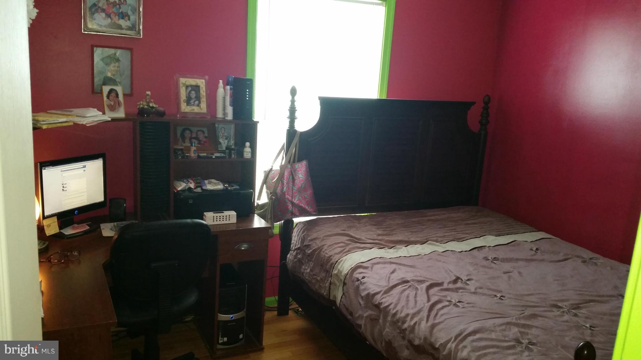 203 Preston Ranson, WV 25438 - Photo 8 of 12 a bed sitting in a bedroom next to a lamp