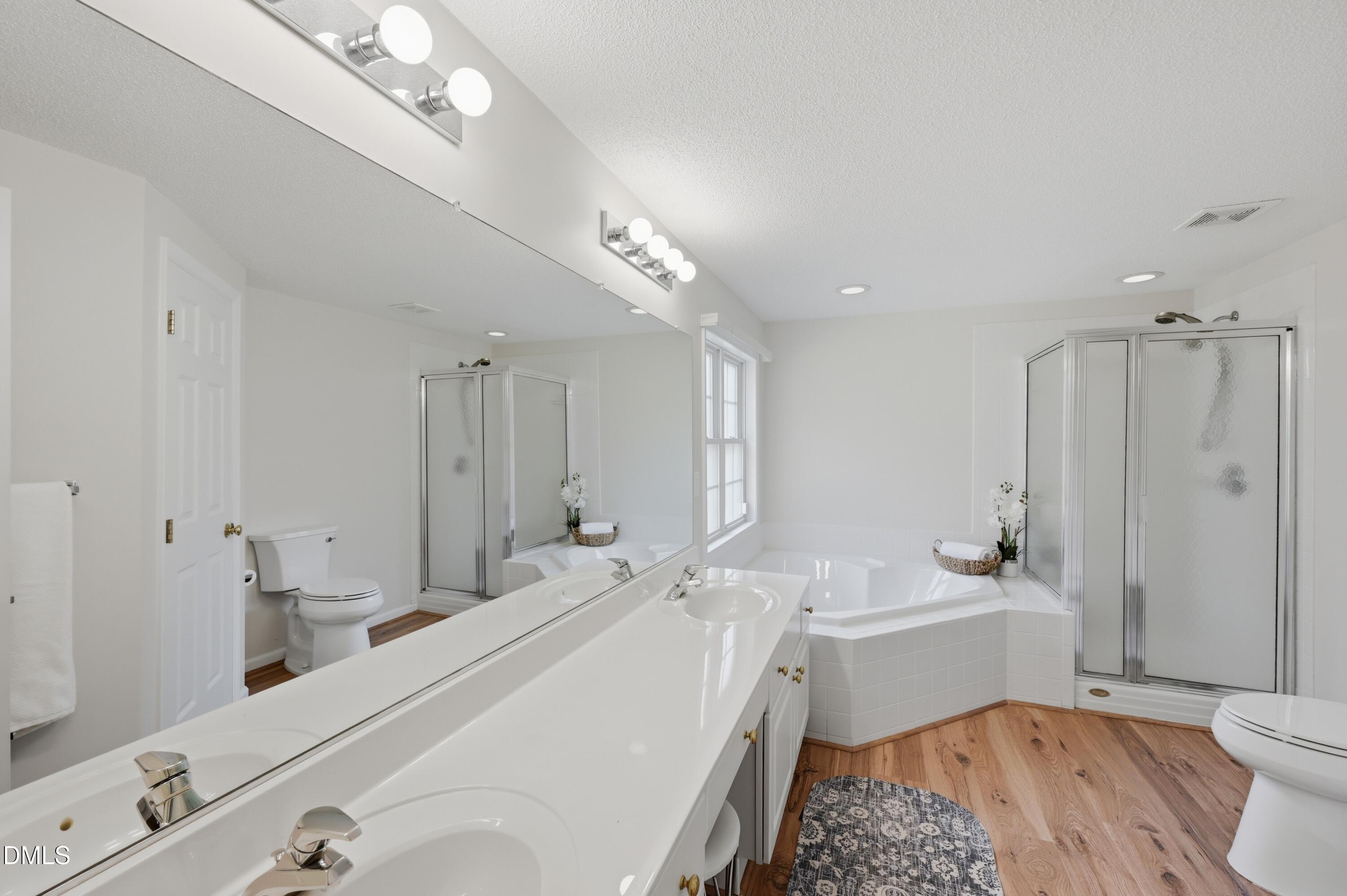 6801 Lynnoak Drive Raleigh, NC 27613 - Photo 16 of 30 a bathroom with a sink a toilet and shower