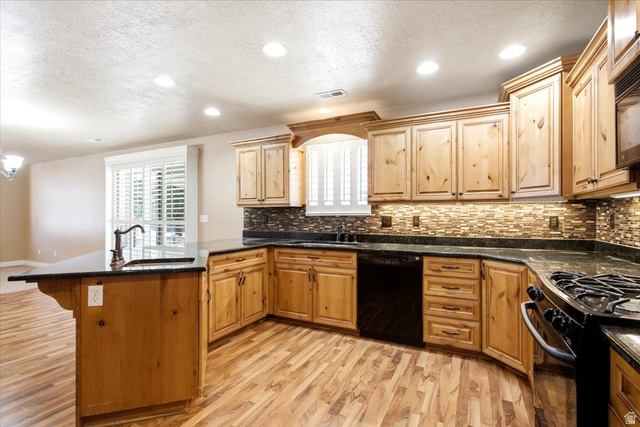 1089 West 2325th Street North Layton, UT 84041 - Photo 10 of 40 Spacious kitchen featuring a large island with a sink, light wood cabinetry, dark countertops, a tiled backsplash, and recessed lighting