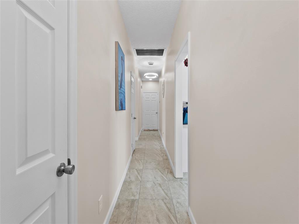 4480 23rd Way Vero Beach, FL 32966 - Photo 12 of 29 a view of a hallway with wooden floor and closet