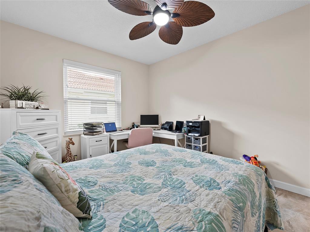 4480 23rd Way Vero Beach, FL 32966 - Photo 15 of 29 a bed room with a bed and a chair
